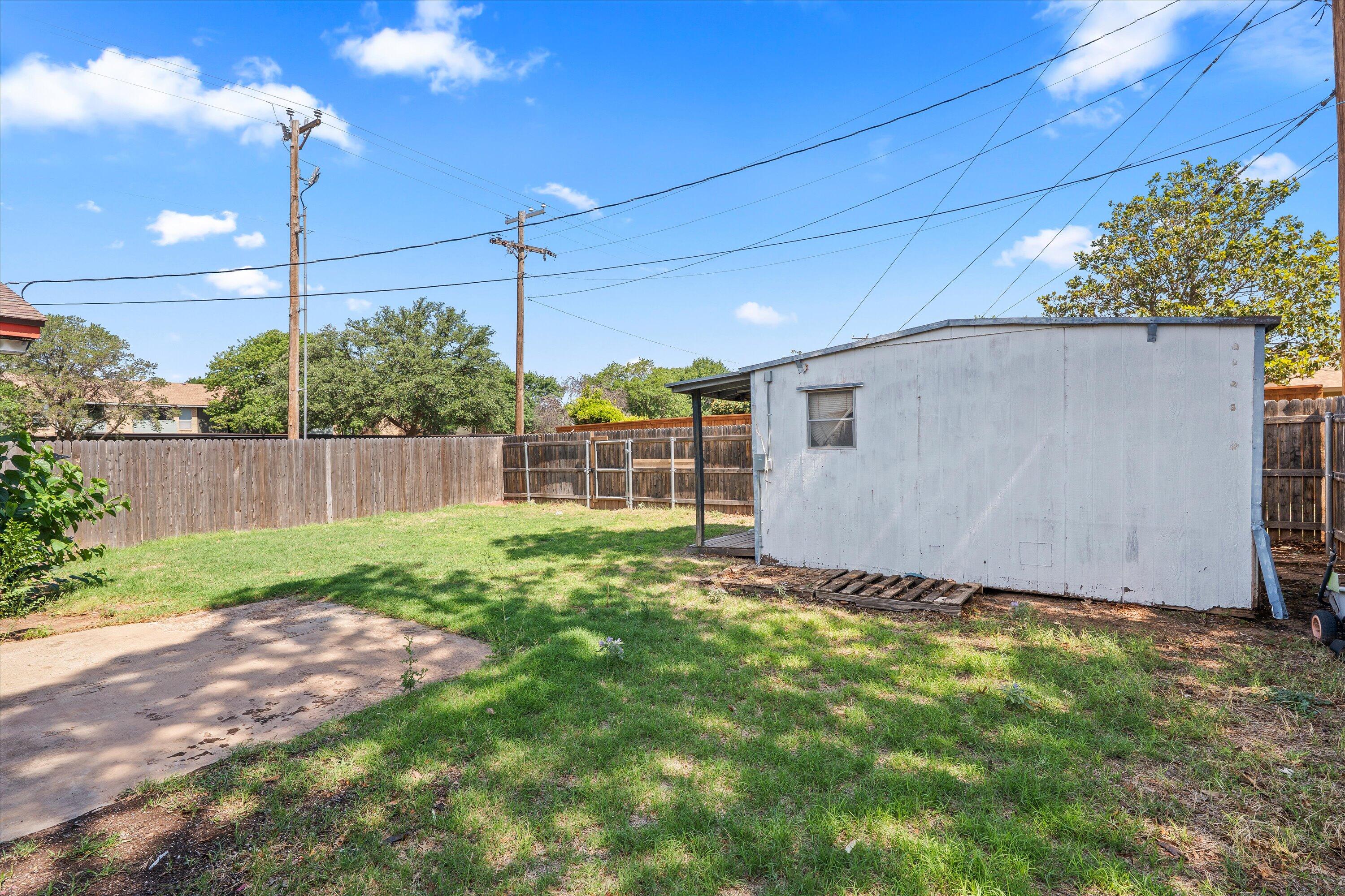4520 54th Street Lubbock, TX 79414 - Photo 26 of 32 a view of a backyard with potted plants