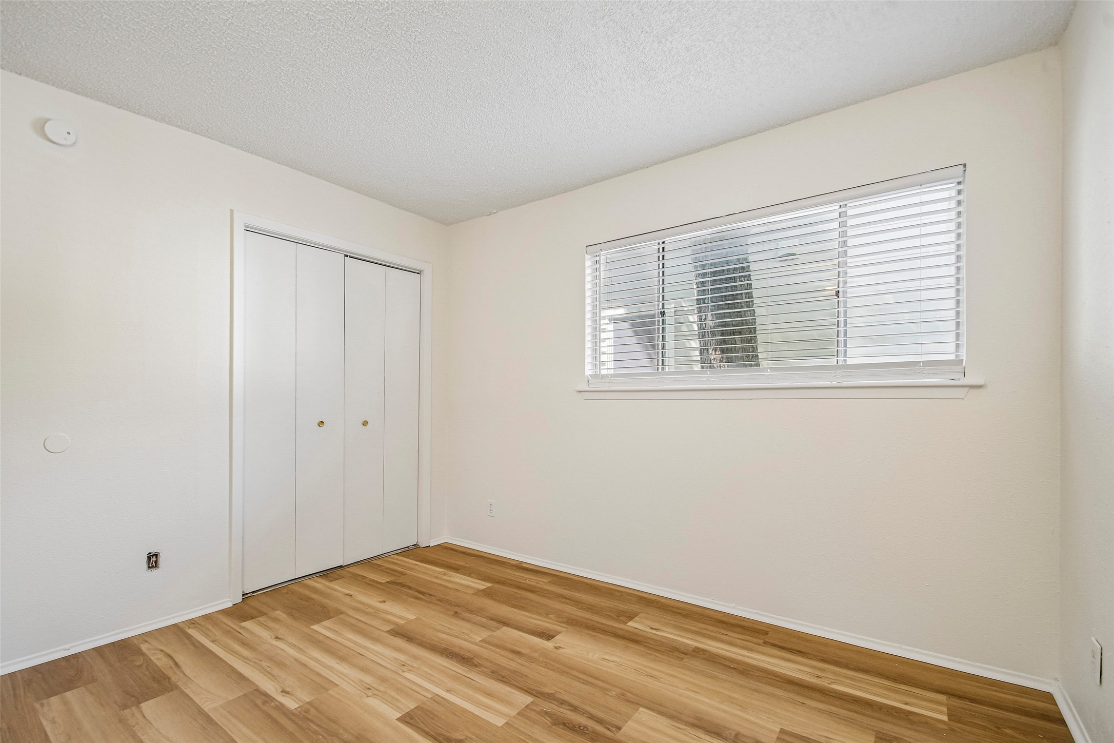 2413 Leon Street, Unit 104 Austin, TX 78705 - Photo 23 of 26 a view of empty room with wooden floor