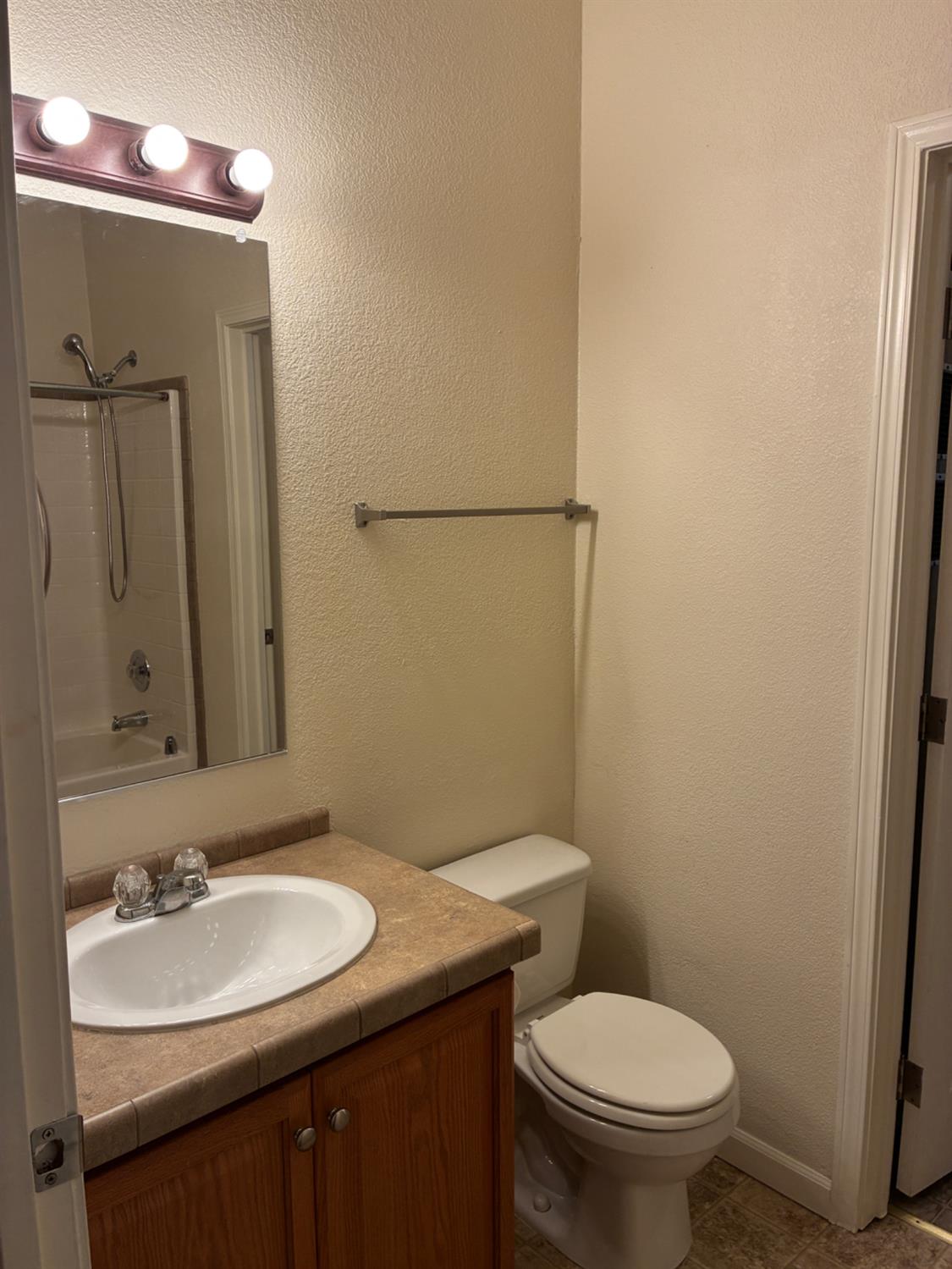 1155 Pease Road, Unit 408 Yuba City, CA 95991 - Photo 20 of 45 a bathroom with a sink toilet and mirror
