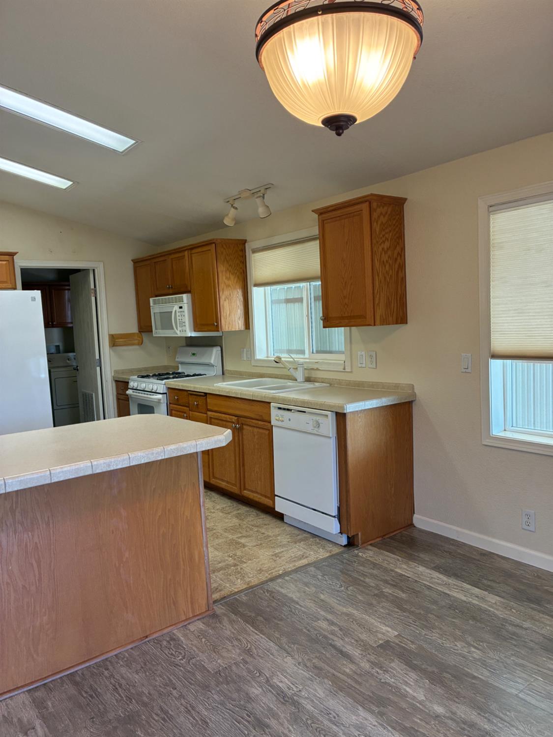 1155 Pease Road, Unit 408 Yuba City, CA 95991 - Photo 6 of 45 a large kitchen with stainless steel appliances granite countertop a sink counter space cabinets and a window