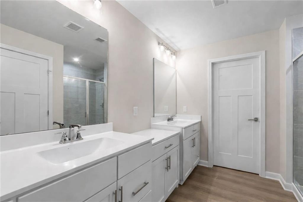 116 Salt Lk Lane Hoschton, GA 30548 - Photo 11 of 17 a bathroom with double vanity sinks and a mirror