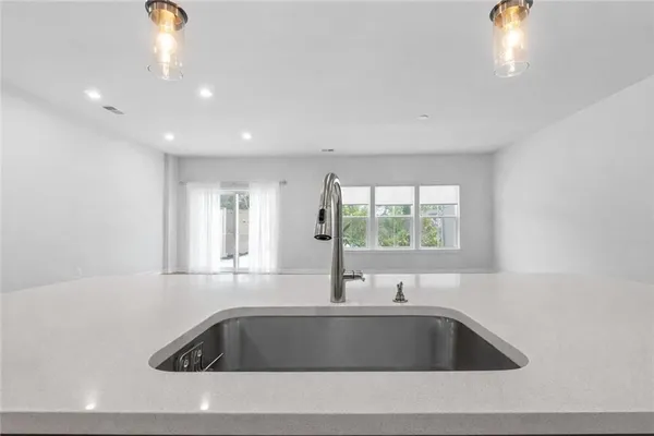 a view of kitchen with sink and window