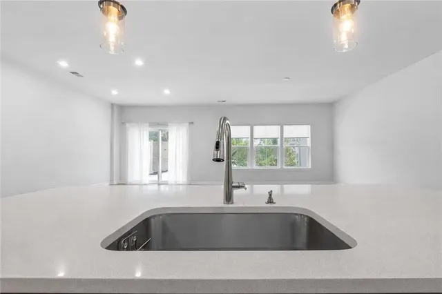 a view of kitchen with sink and window