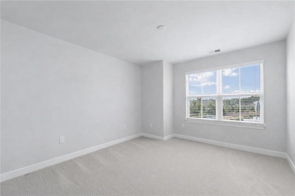 116 Salt Lk Lane Hoschton, GA 30548 - Photo 7 of 17 an empty room with a window