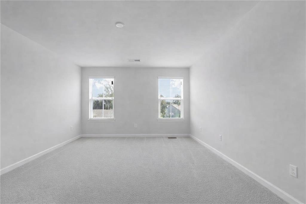 116 Salt Lk Lane Hoschton, GA 30548 - Photo 9 of 17 an empty room with windows