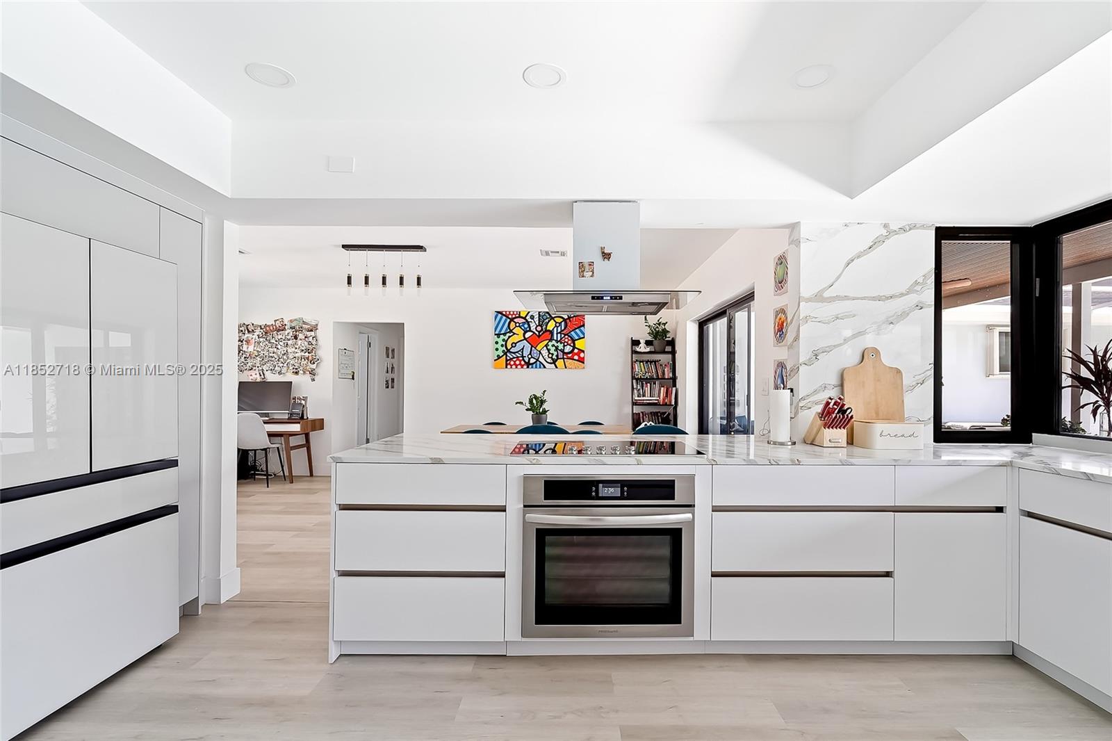 a kitchen with stainless steel appliances granite countertop a stove and a refrigerator