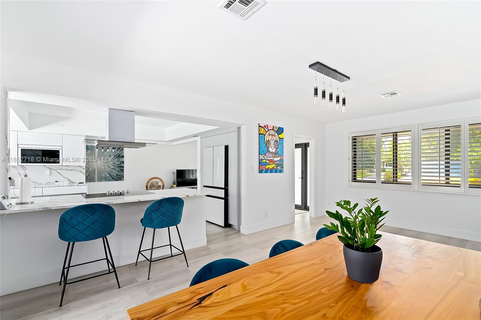 5100 Arthur Street Hollywood, FL 33021 - Photo 12 of 54 a kitchen with a table and chairs