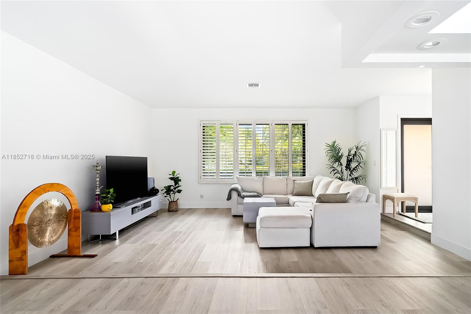 5100 Arthur Street Hollywood, FL 33021 - Photo 14 of 54 a living room with furniture a flat screen tv and a large window