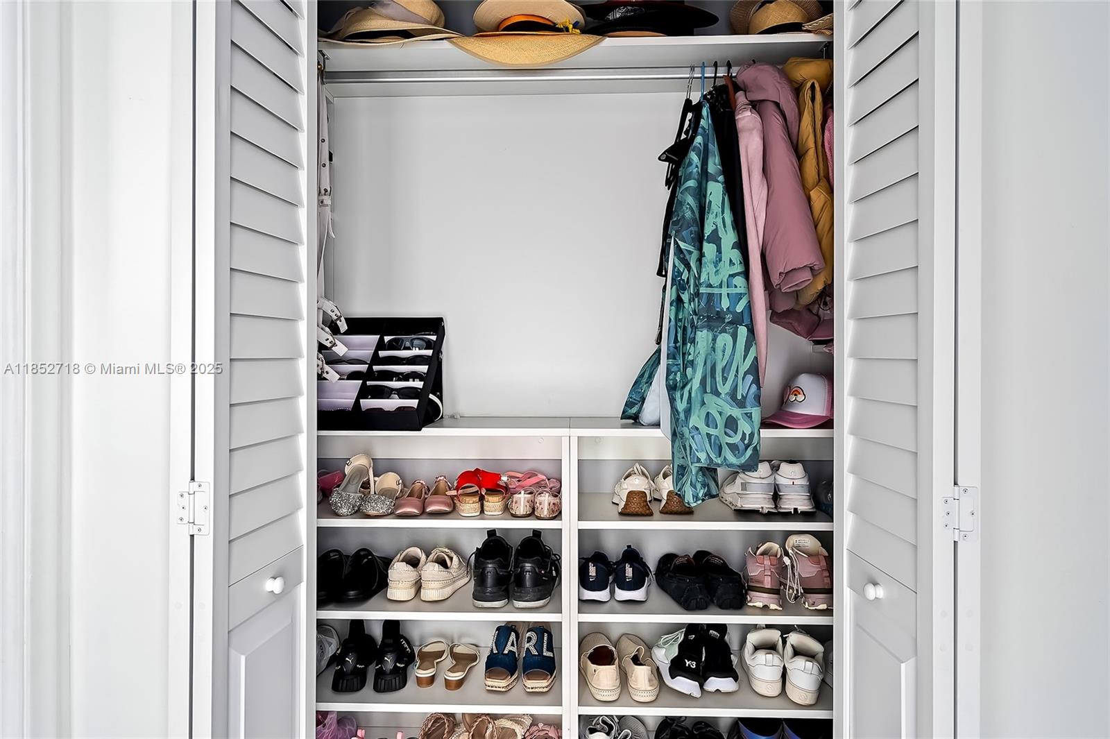 5100 Arthur Street Hollywood, FL 33021 - Photo 18 of 54 a view of walk in closet with clothes and shoes
