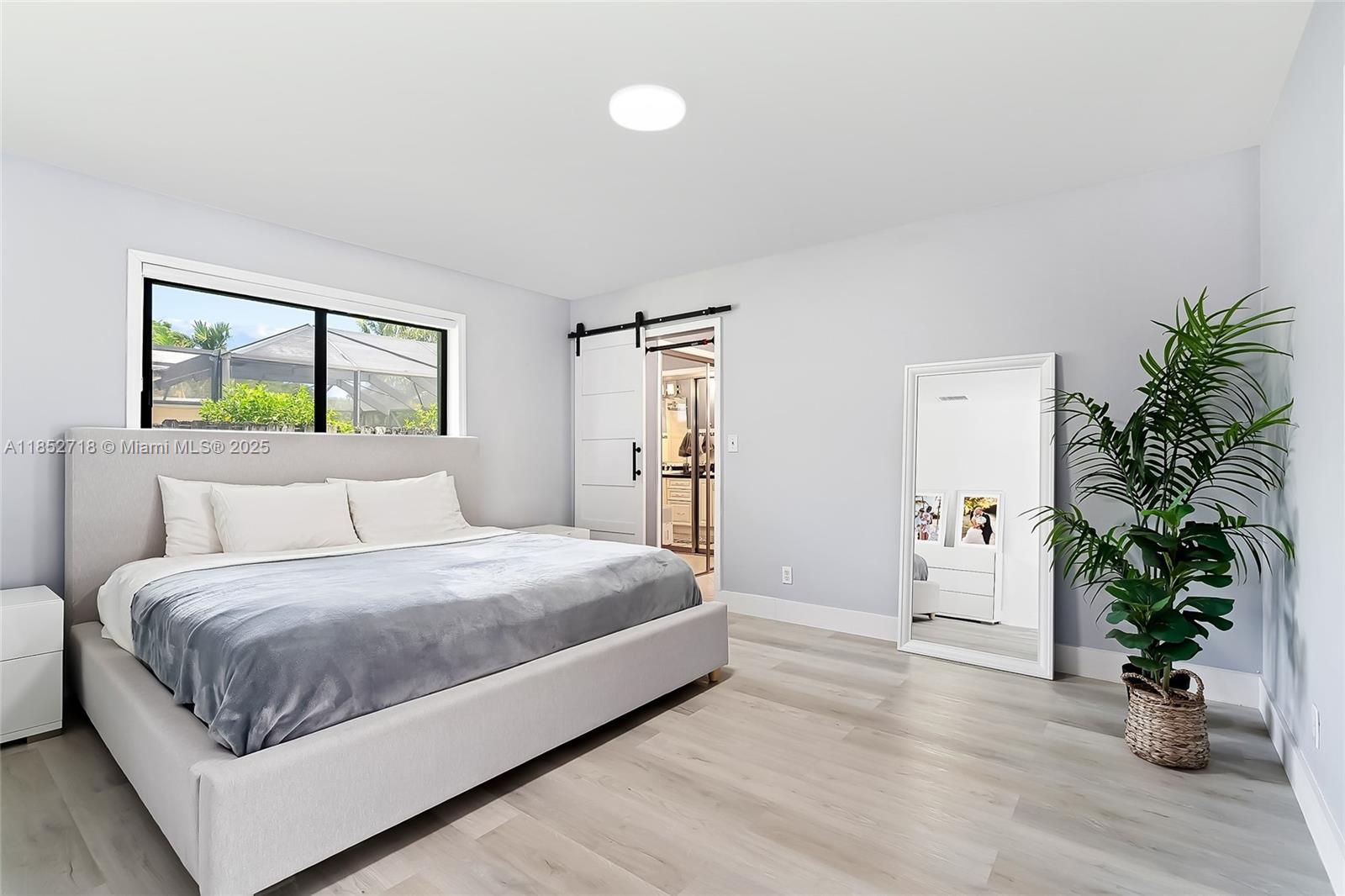 5100 Arthur Street Hollywood, FL 33021 - Photo 20 of 54 a bedroom with a large bed and a potted plant