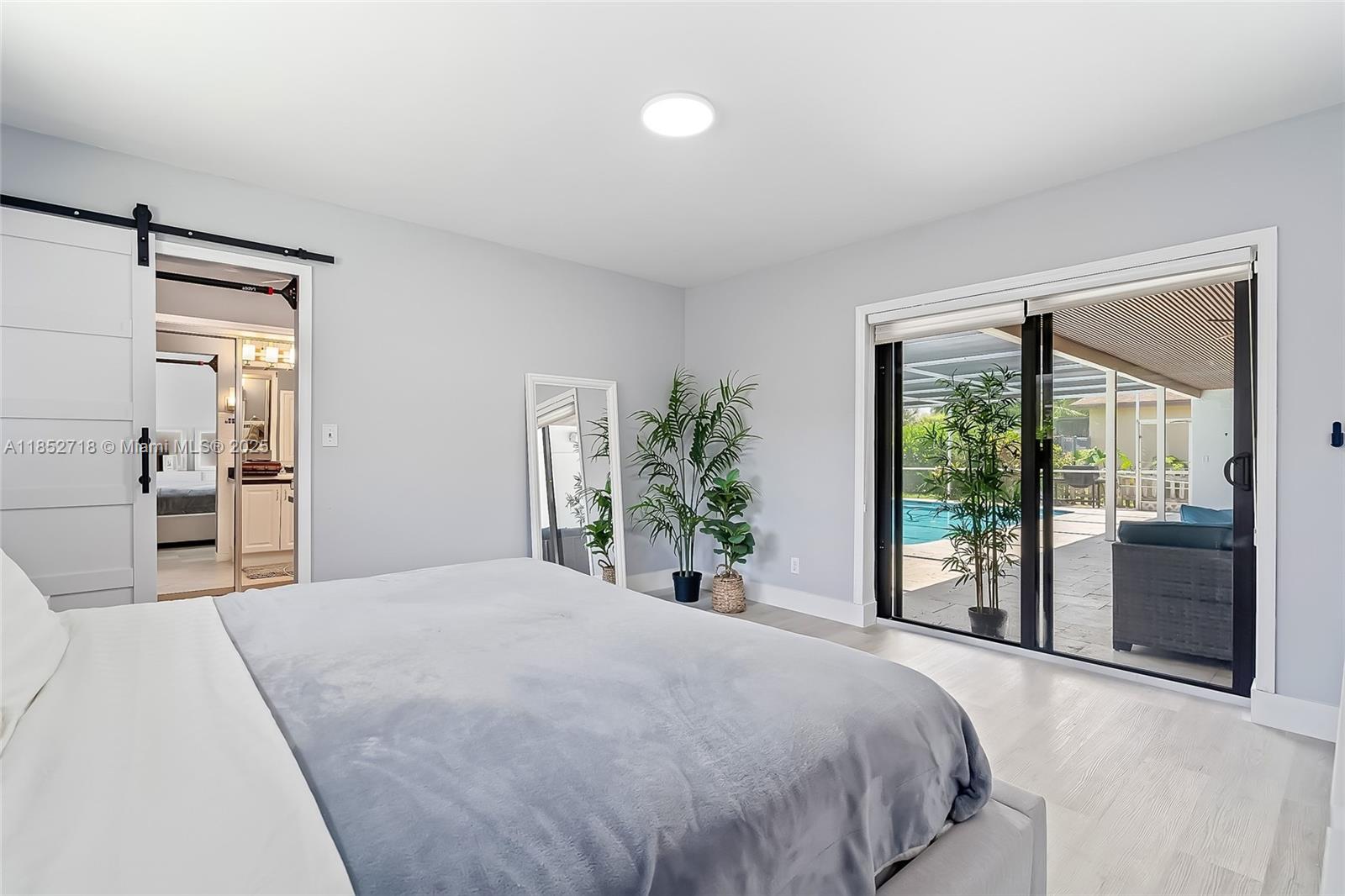 5100 Arthur Street Hollywood, FL 33021 - Photo 22 of 54 a bedroom with a large bed and a large window