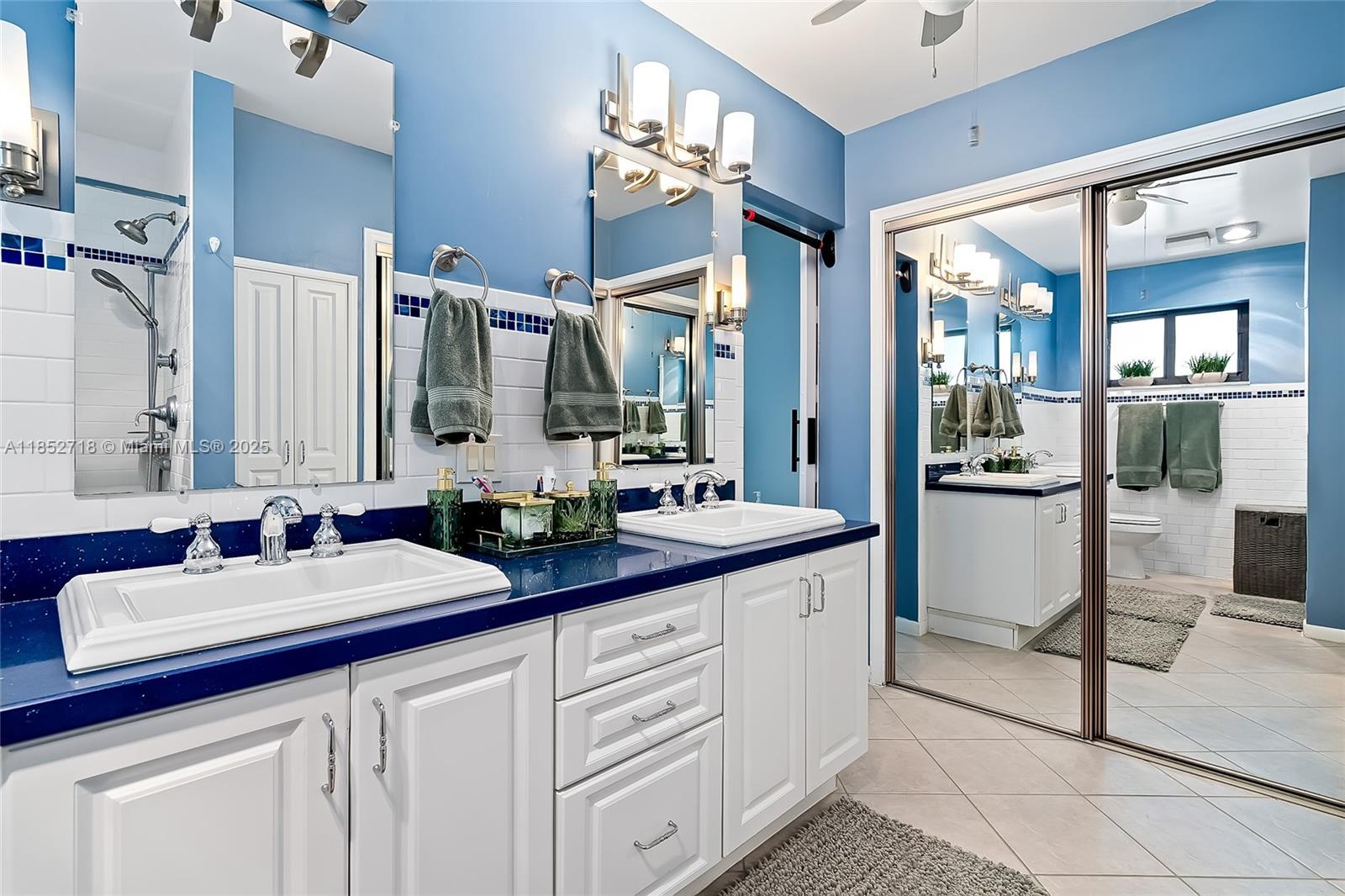 5100 Arthur Street Hollywood, FL 33021 - Photo 23 of 54 a bathroom with a sink double vanity granite and a mirror