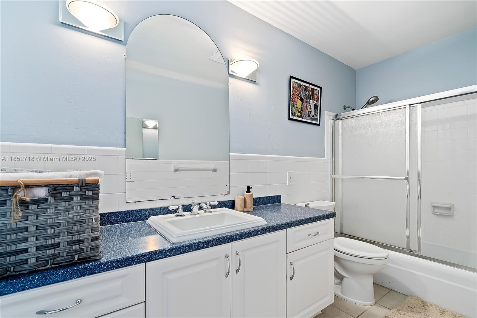 5100 Arthur Street Hollywood, FL 33021 - Photo 28 of 54 a bathroom with a granite countertop sink a toilet and a mirror