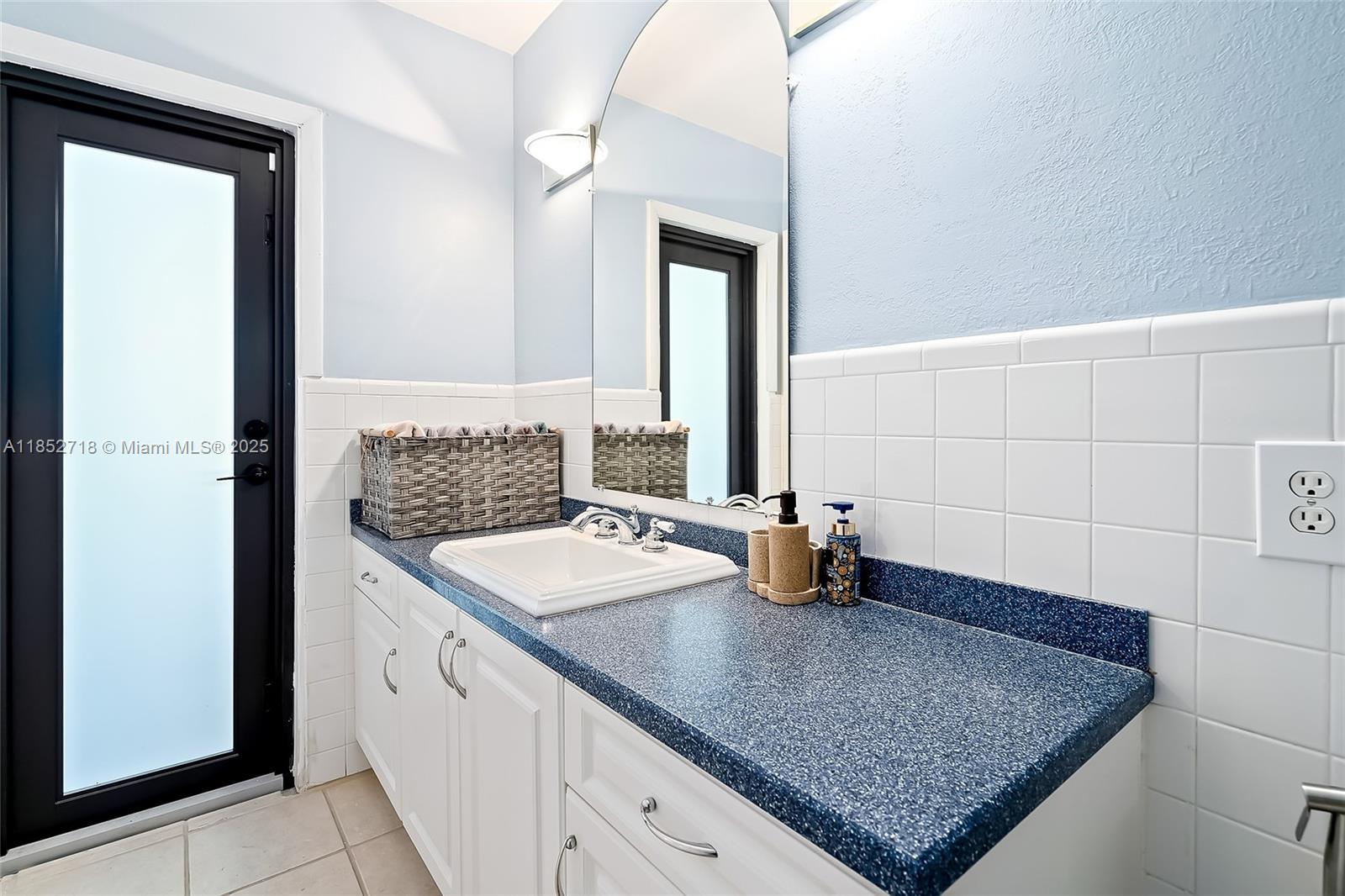 5100 Arthur Street Hollywood, FL 33021 - Photo 29 of 54 a bathroom with a granite countertop sink and a mirror
