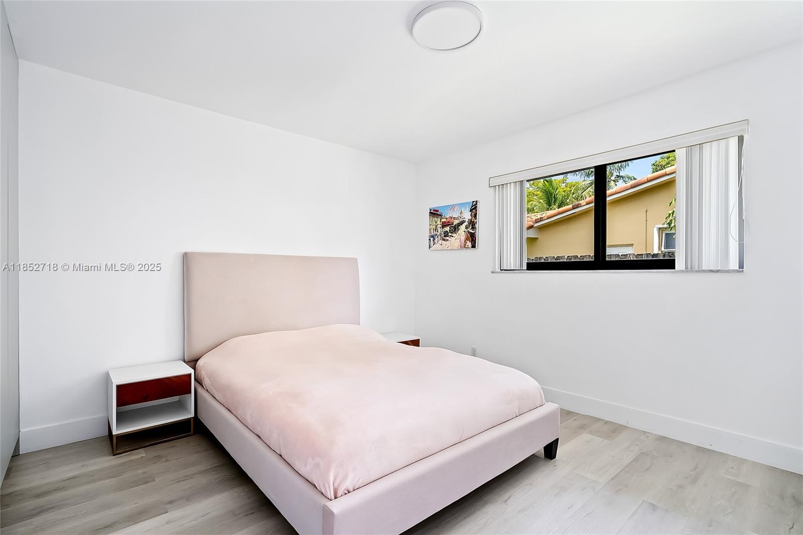 5100 Arthur Street Hollywood, FL 33021 - Photo 31 of 54 a bedroom with a bed and painting on the wall