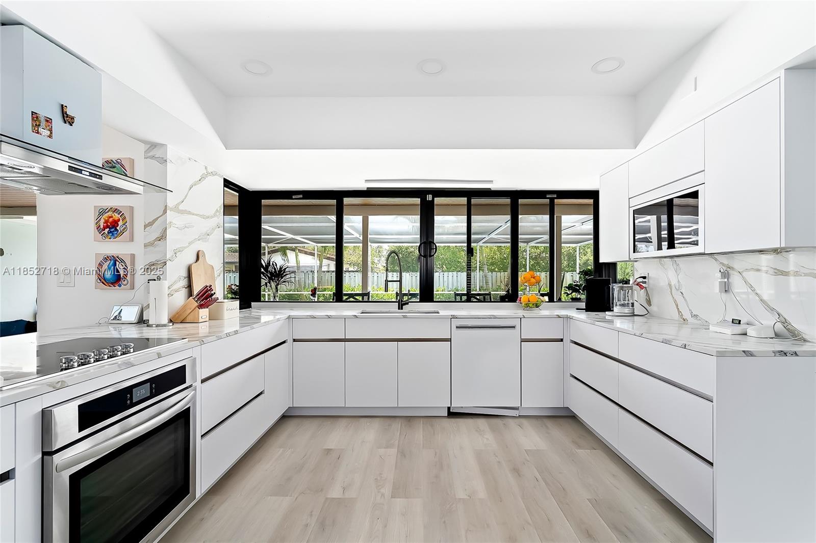 5100 Arthur Street Hollywood, FL 33021 - Photo 4 of 54 a large white kitchen with a large window