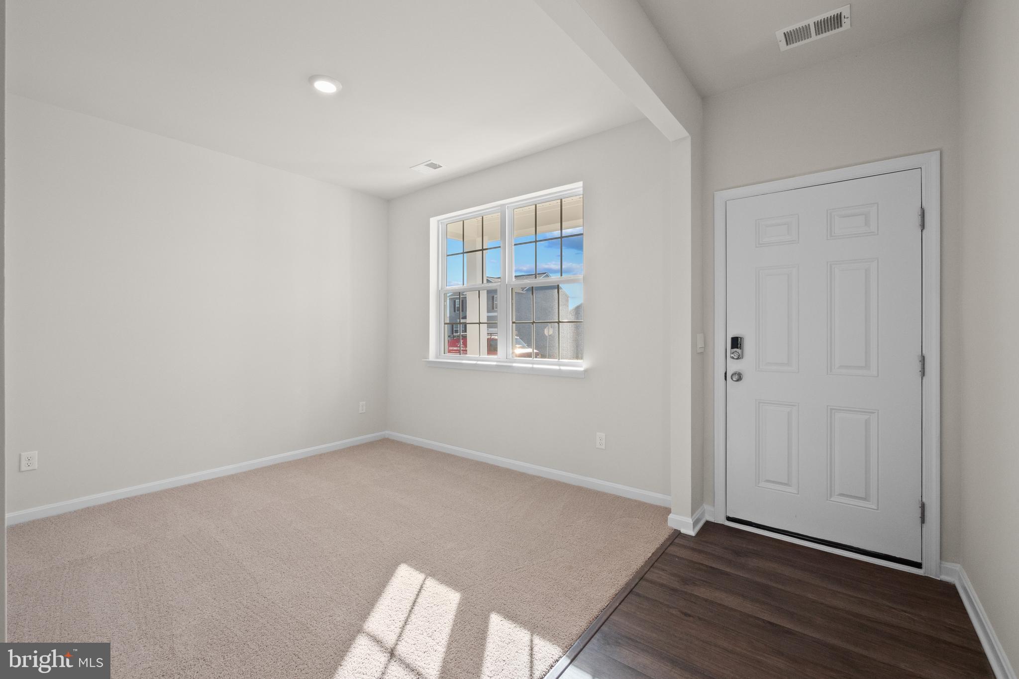 348 Eclipse Street Ranson, WV 25438 - Photo 2 of 29 an empty room with wooden floor and windows