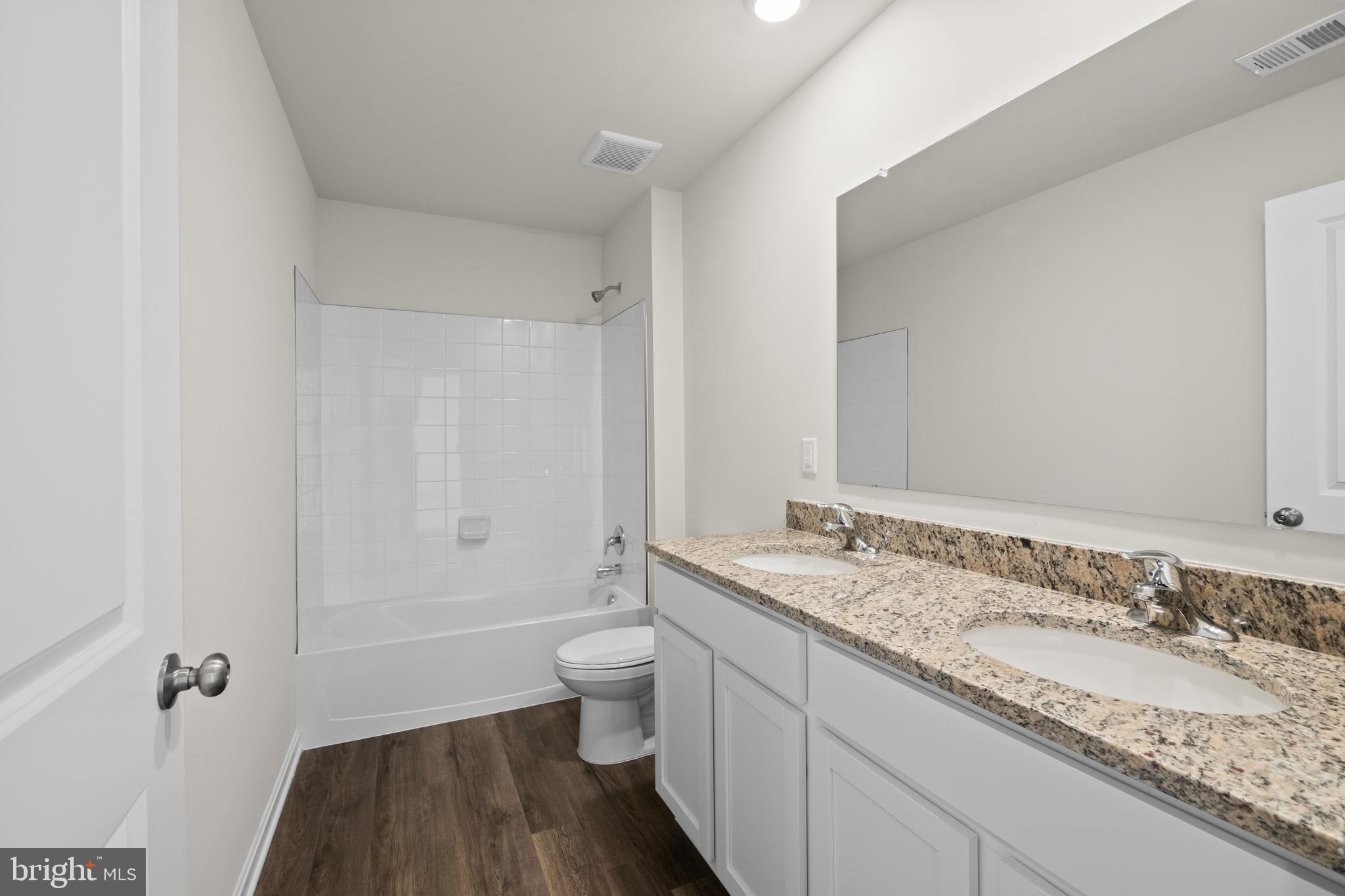 348 Eclipse Street Ranson, WV 25438 - Photo 26 of 29 a bathroom with a granite countertop sink and a mirror