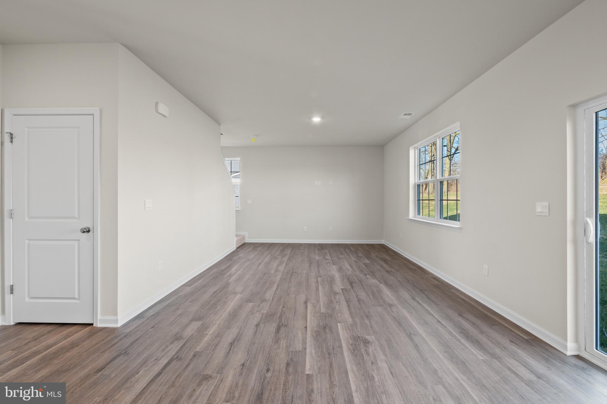 348 Eclipse Street Ranson, WV 25438 - Photo 5 of 29 wooden floor in an empty room with a window