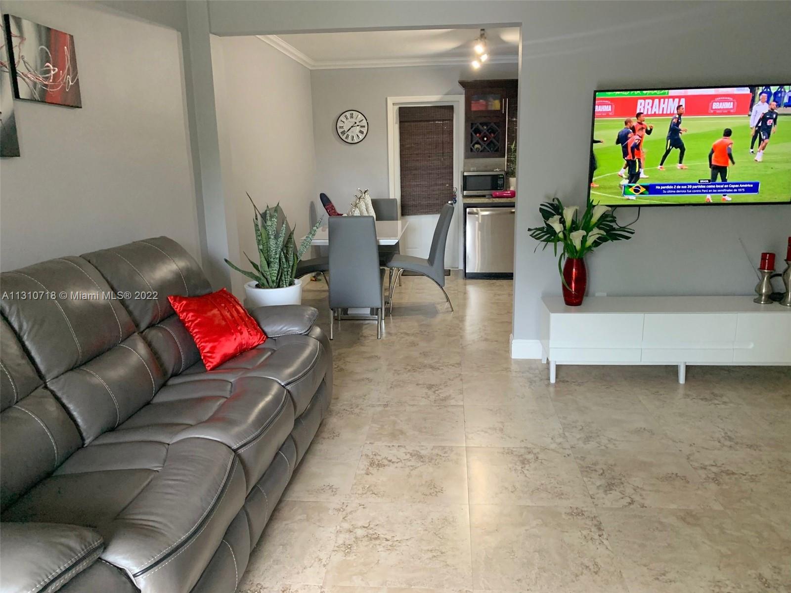 Flagami Miami, FL 33126 - Photo 14 of 21 a living room with furniture and flowers