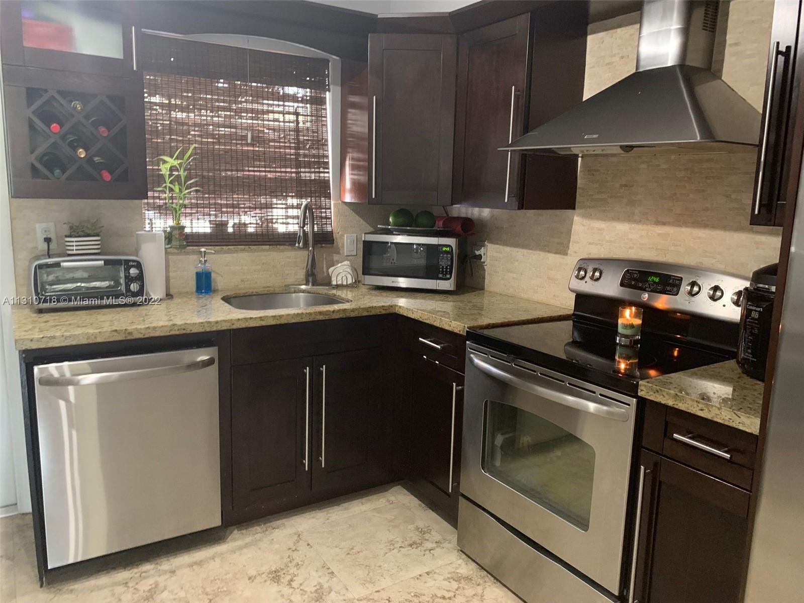 Flagami Miami, FL 33126 - Photo 16 of 21 a kitchen with a stove and a microwave