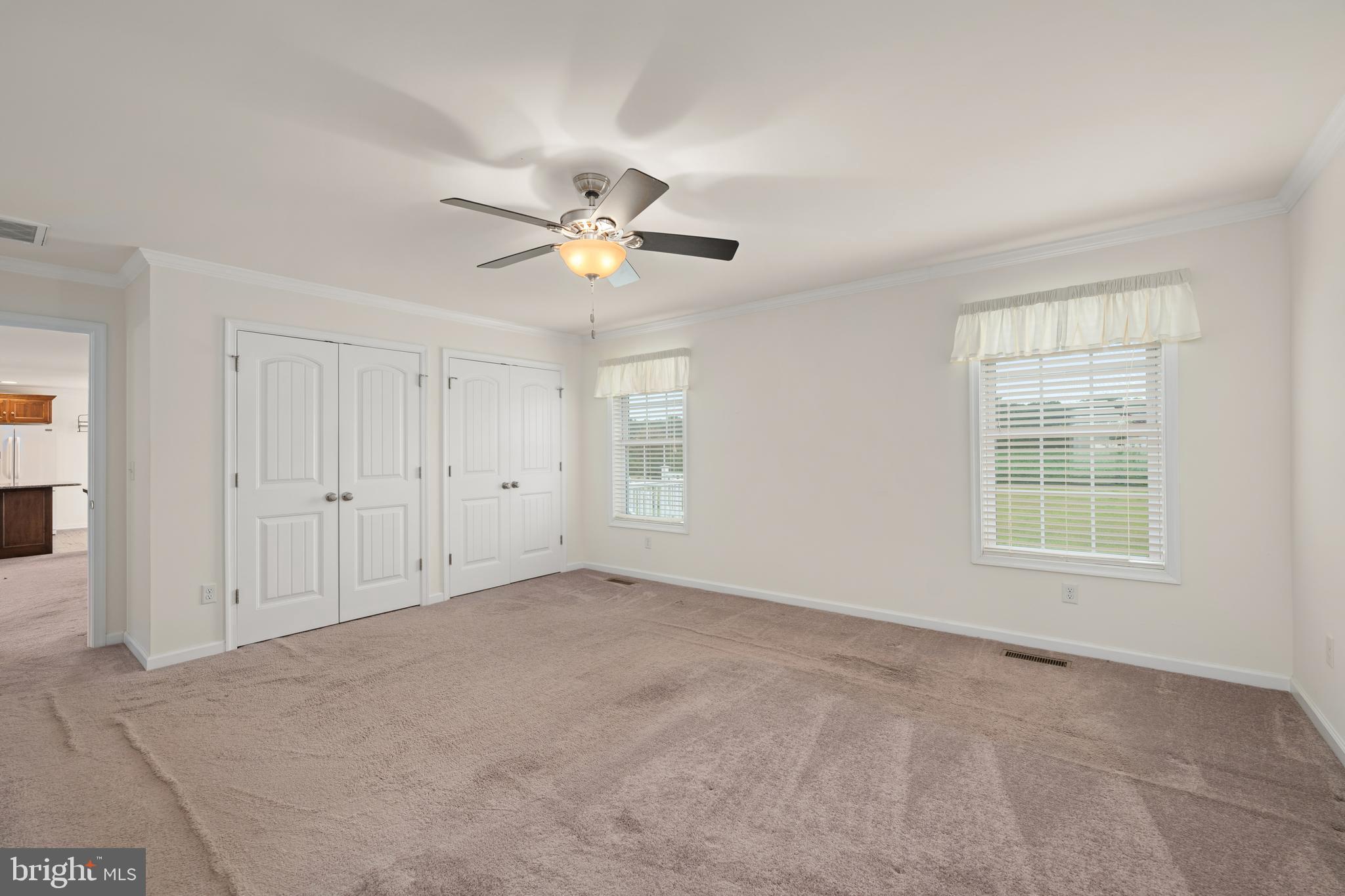 17002 Oak Road Bridgeville, DE 19933 - Photo 14 of 33 an empty room with chandelier fan and windows