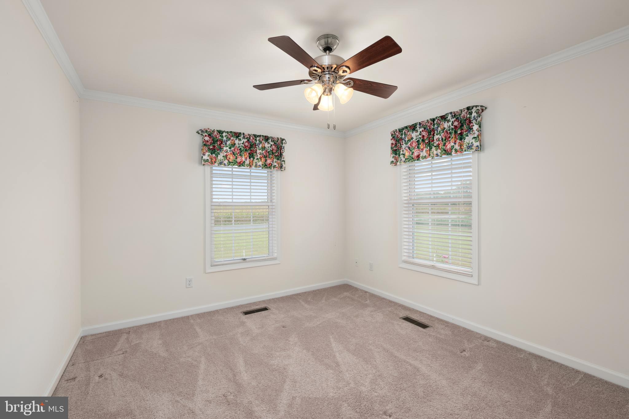 17002 Oak Road Bridgeville, DE 19933 - Photo 17 of 33 an empty room with a window and a ceiling fan