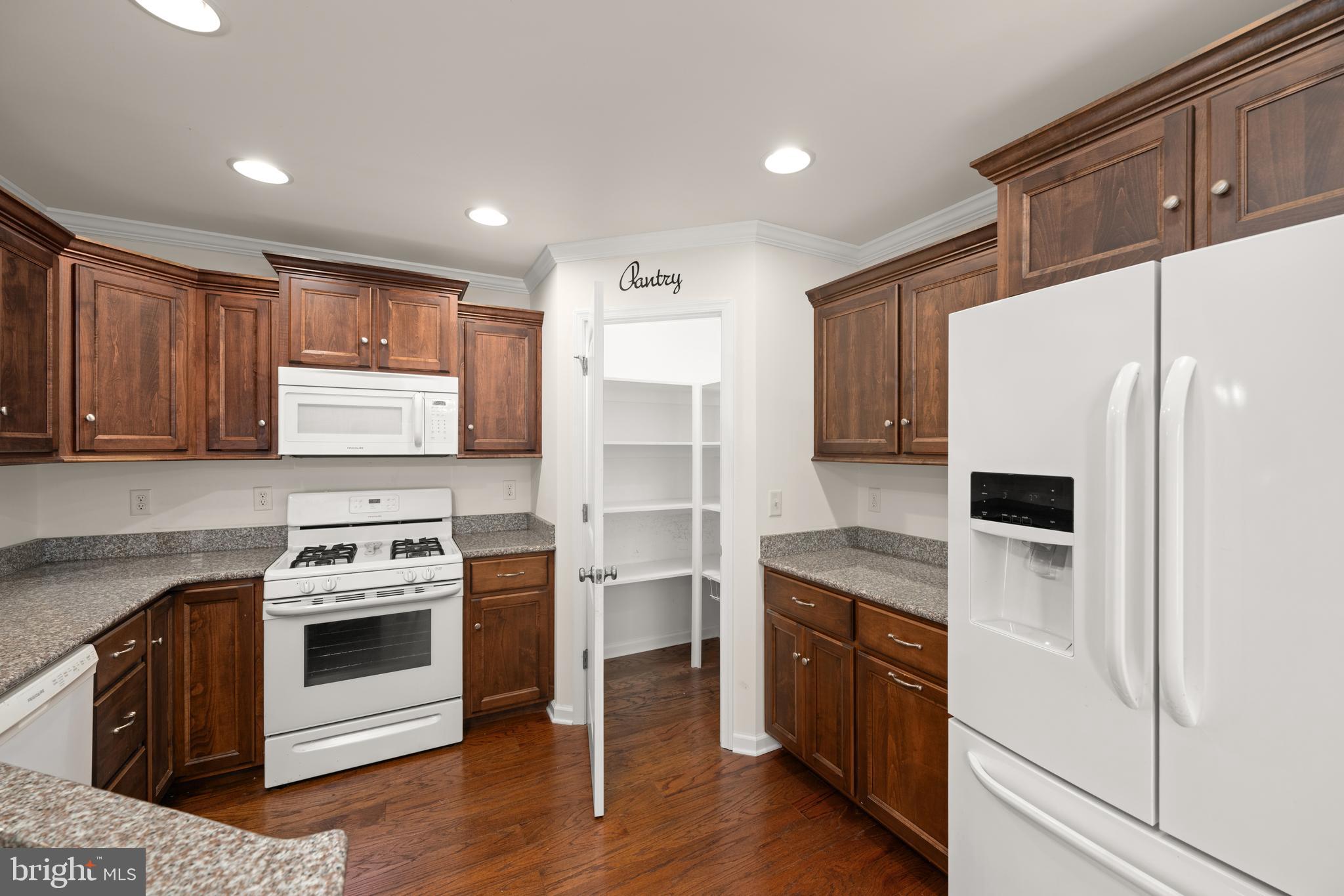 17002 Oak Road Bridgeville, DE 19933 - Photo 8 of 33 a kitchen with a stove a microwave and a refrigerator