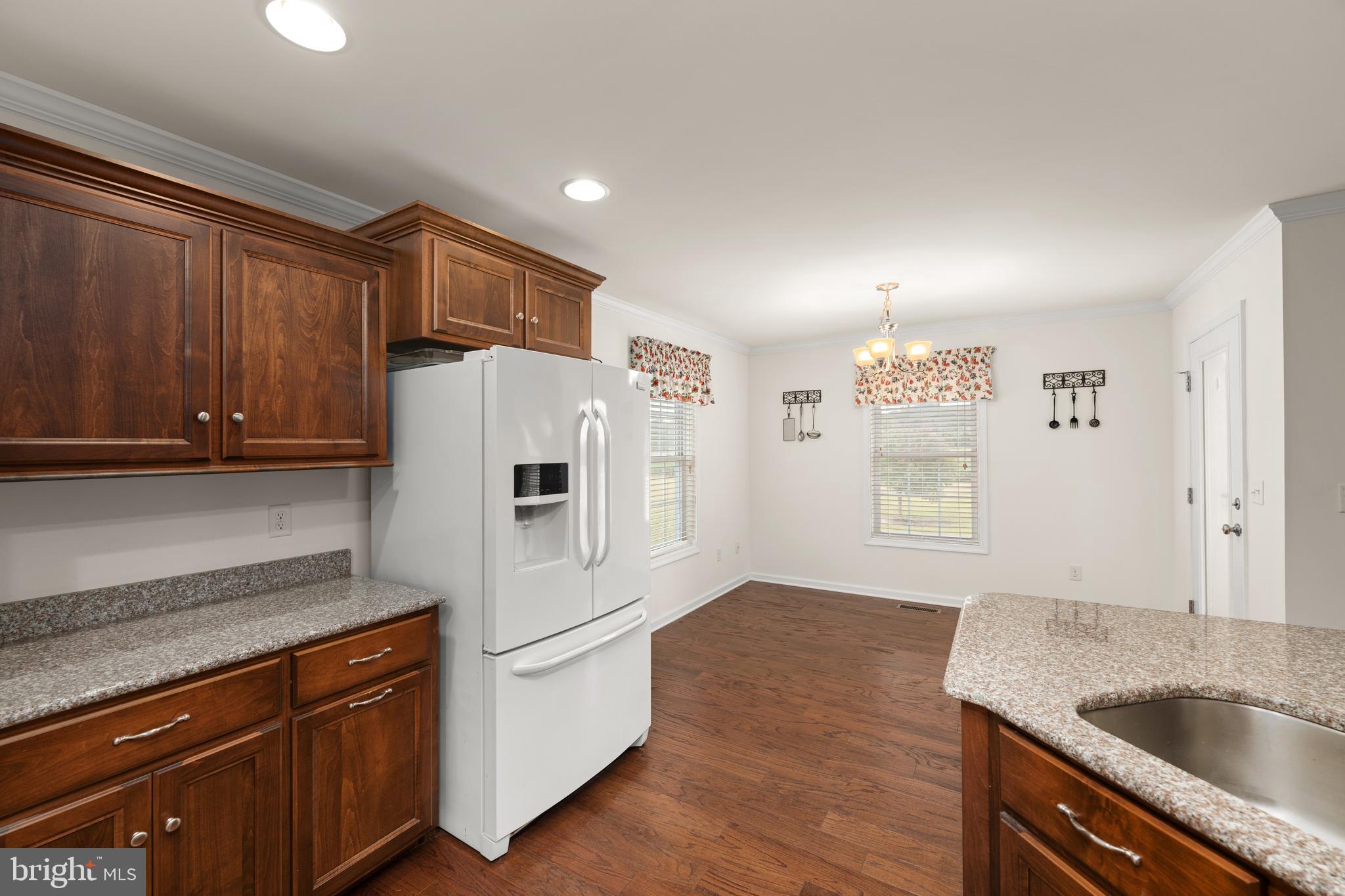 17002 Oak Road Bridgeville, DE 19933 - Photo 9 of 33 a kitchen with granite countertop a sink stove and refrigerator