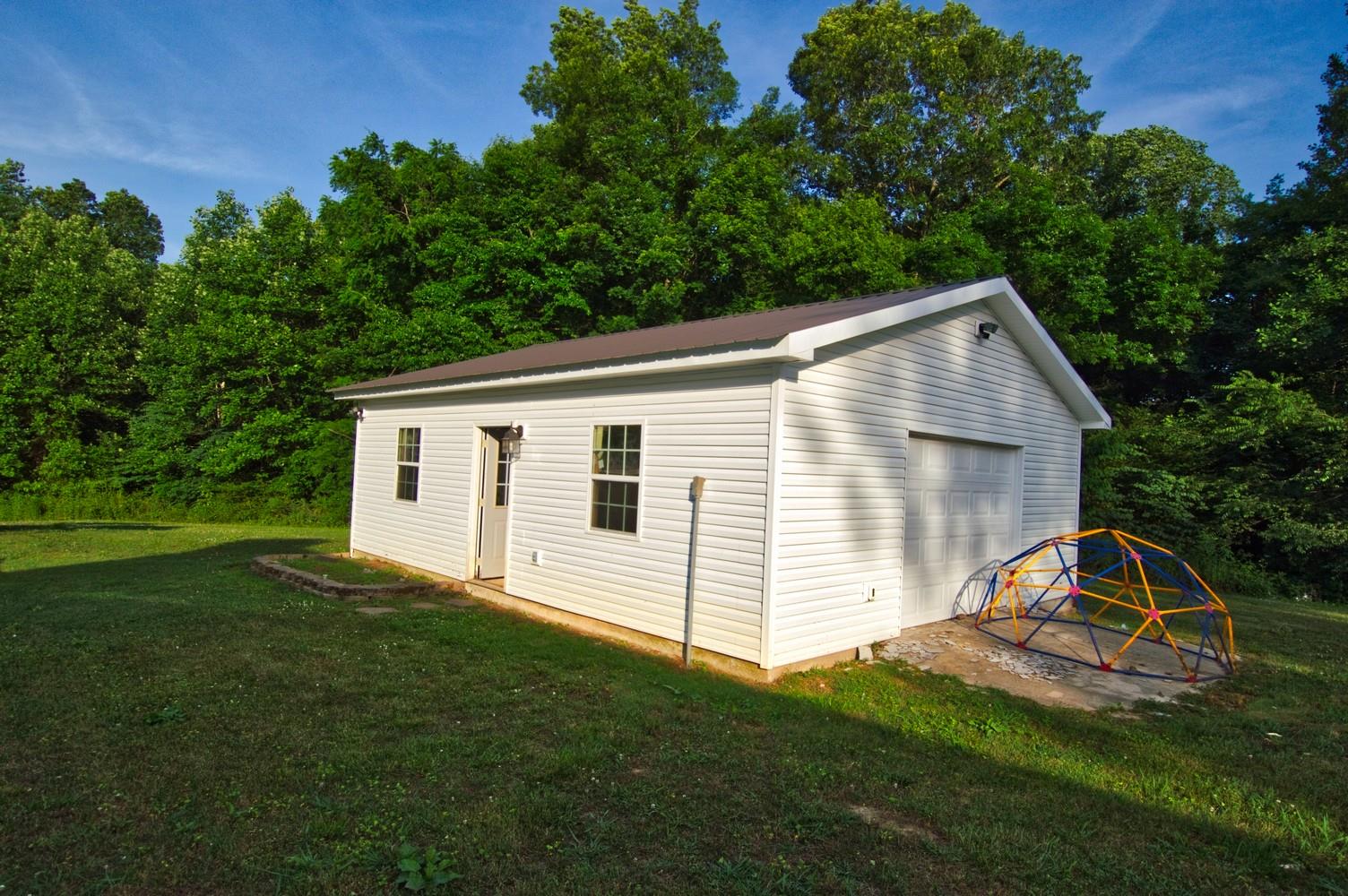 986 McClain Road Morrison, TN 37357 - Photo 4 of 19 a view of a backyard with a garden and entertaining space
