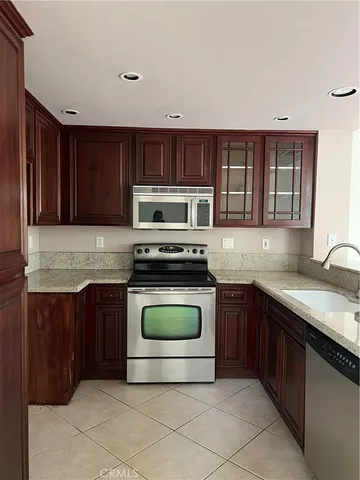 a kitchen with a sink a stove and cabinets