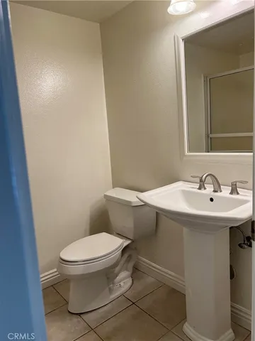 a white toilet sitting next to a bathroom sink