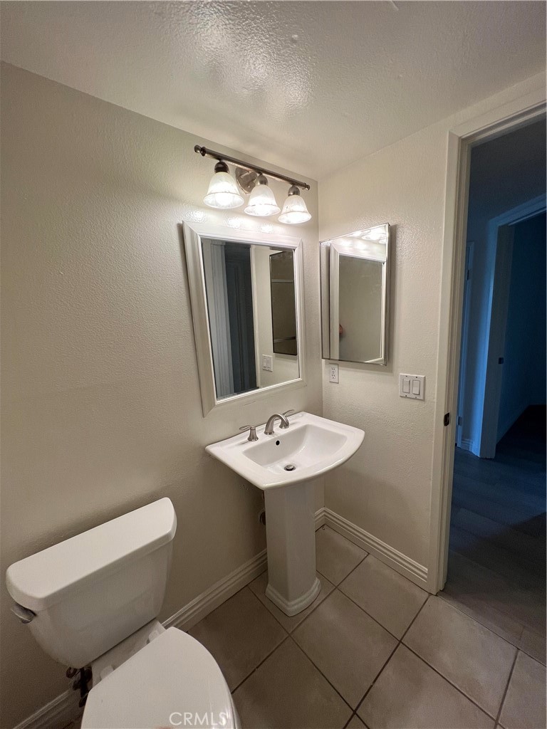 81 Stanford Court, Unit 67 Irvine, CA 92612 - Photo 18 of 30 a bathroom with a toilet sink and mirror