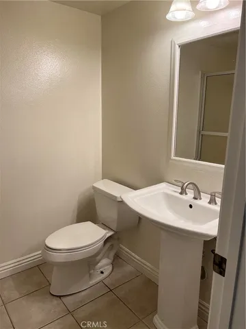 a white toilet sitting next to a bathroom sink