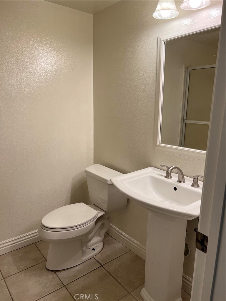81 Stanford Court, Unit 67 Irvine, CA 92612 - Photo 19 of 30 a white toilet sitting next to a bathroom sink