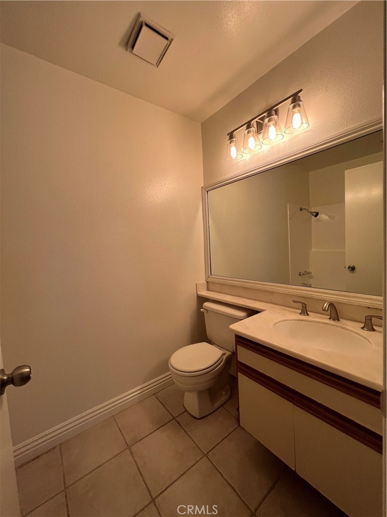 81 Stanford Court, Unit 67 Irvine, CA 92612 - Photo 26 of 30 a bathroom with a granite countertop sink and a mirror
