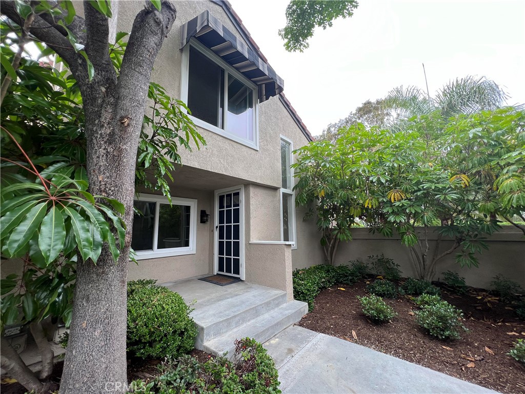 81 Stanford Court, Unit 67 Irvine, CA 92612 - Photo 3 of 30 a front view of a house with garden