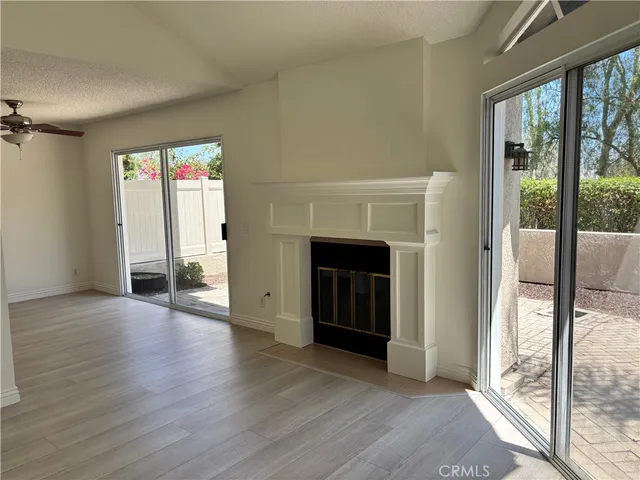 wooden floor fireplace and natural light in room