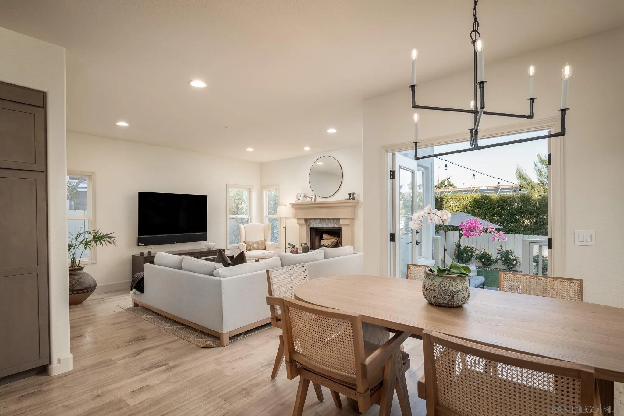 339 Rancho Santa Fe Road Encinitas, CA 92024 - Photo 11 of 36 a living room with furniture a flat screen tv and a fireplace