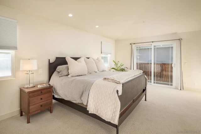 a spacious bedroom with a bed and a table