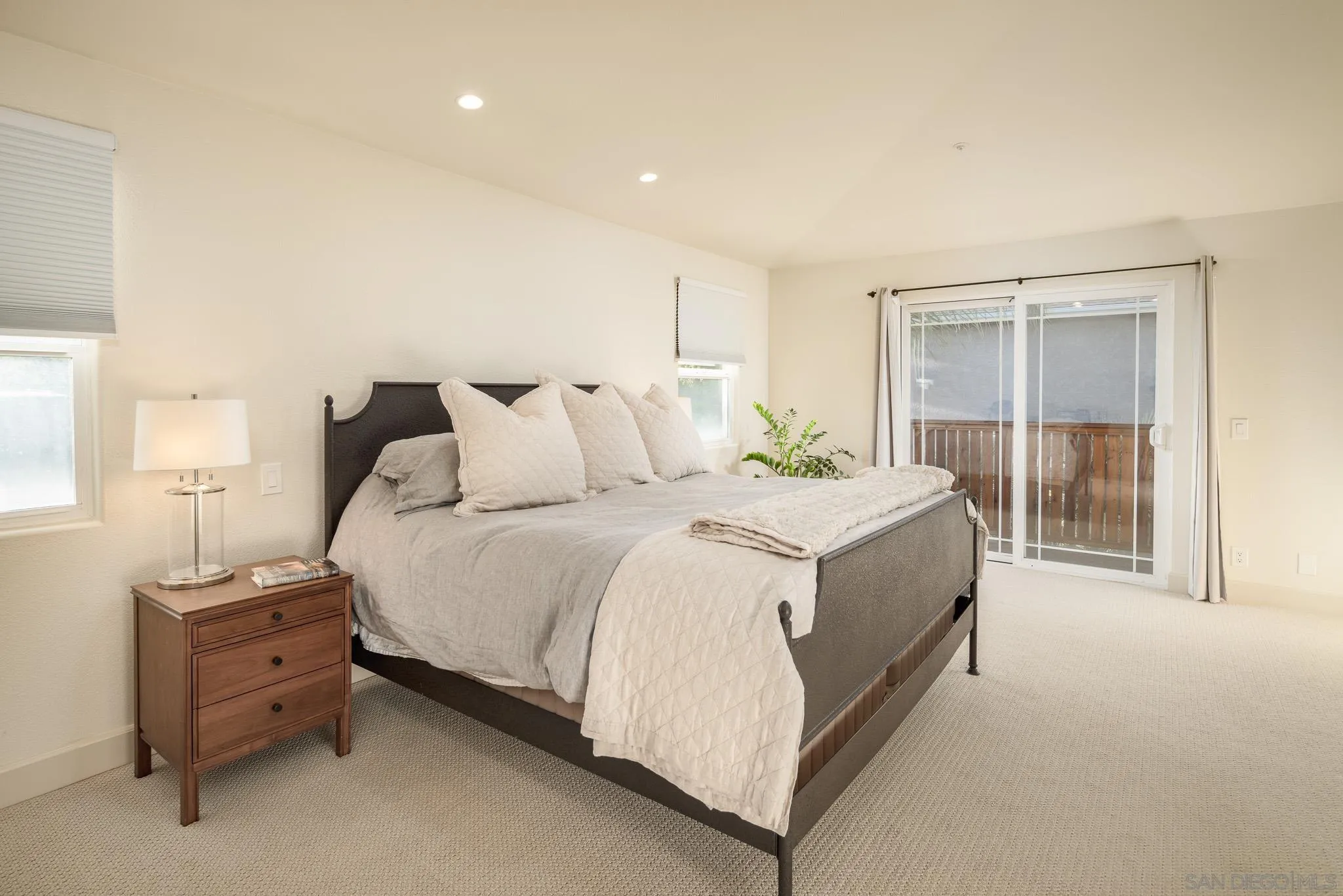339 Rancho Santa Fe Road Encinitas, CA 92024 - Photo 15 of 36 a spacious bedroom with a bed and a table