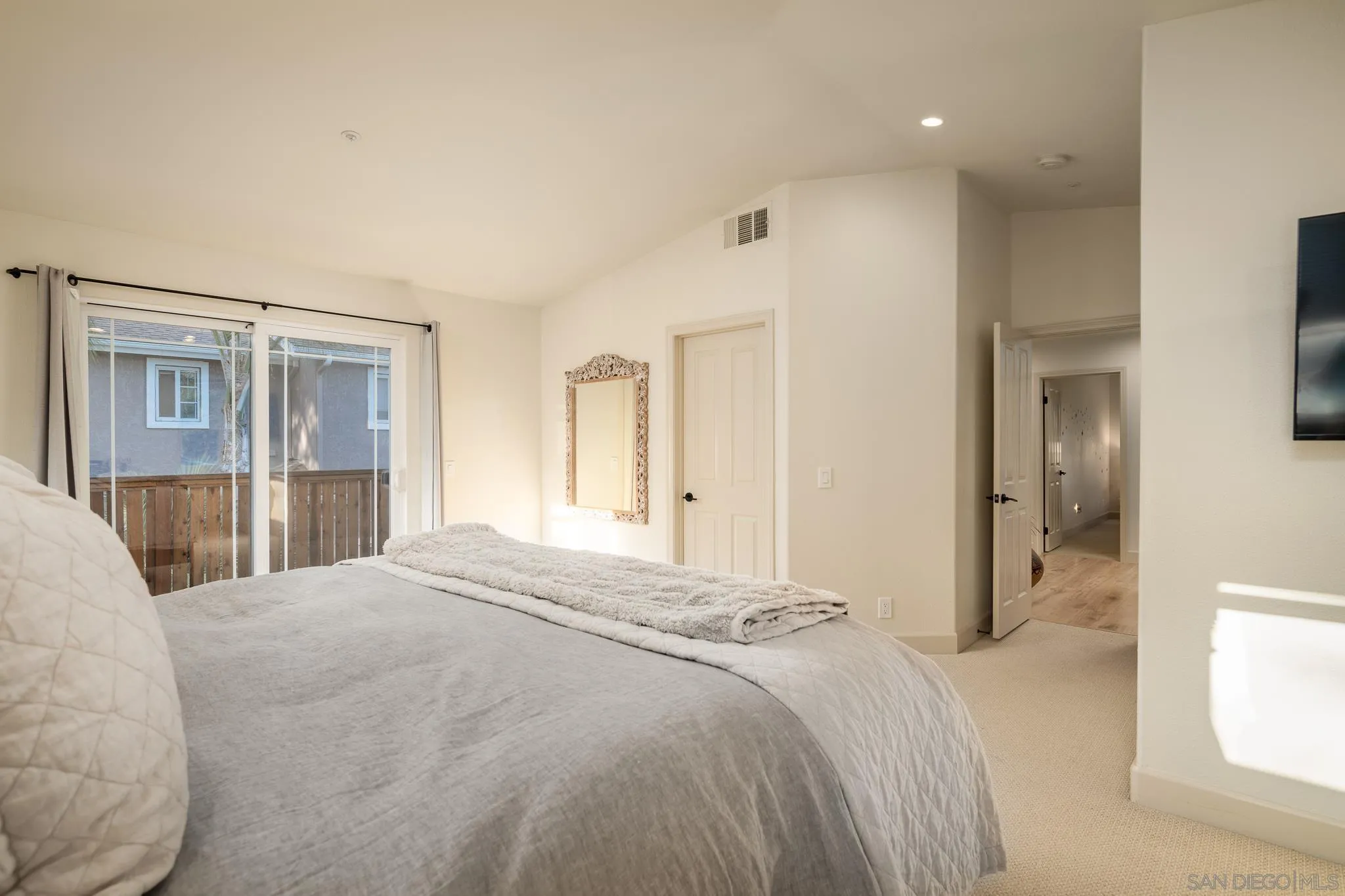 339 Rancho Santa Fe Road Encinitas, CA 92024 - Photo 16 of 36 a spacious bedroom with a bed and a large mirror