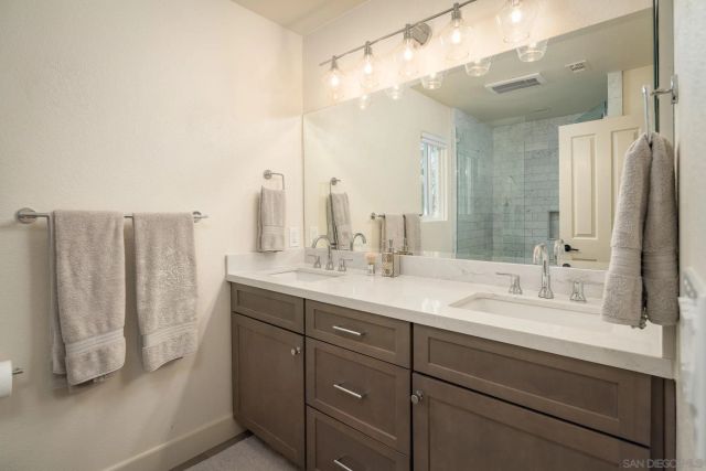 a bathroom with a double vanity sink and mirror
