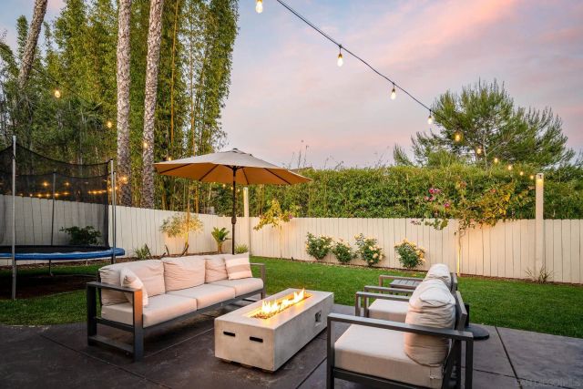 a view of a patio with couches under an umbrella