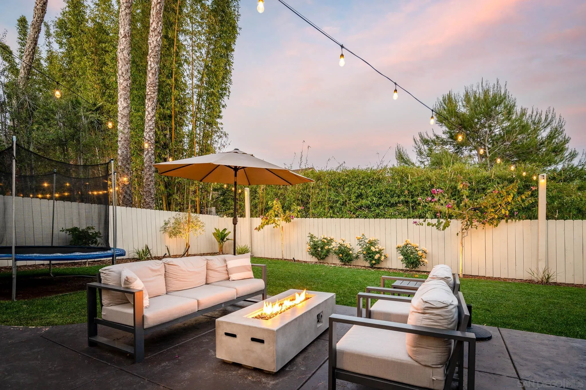 339 Rancho Santa Fe Road Encinitas, CA 92024 - Photo 19 of 36 a view of a patio with couches under an umbrella