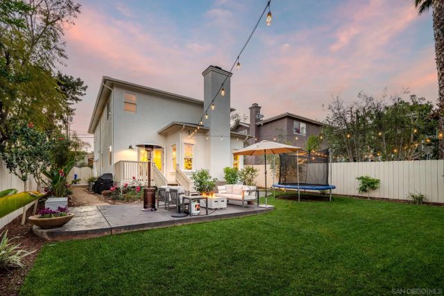 a row of table and chairs with a yard in front of it