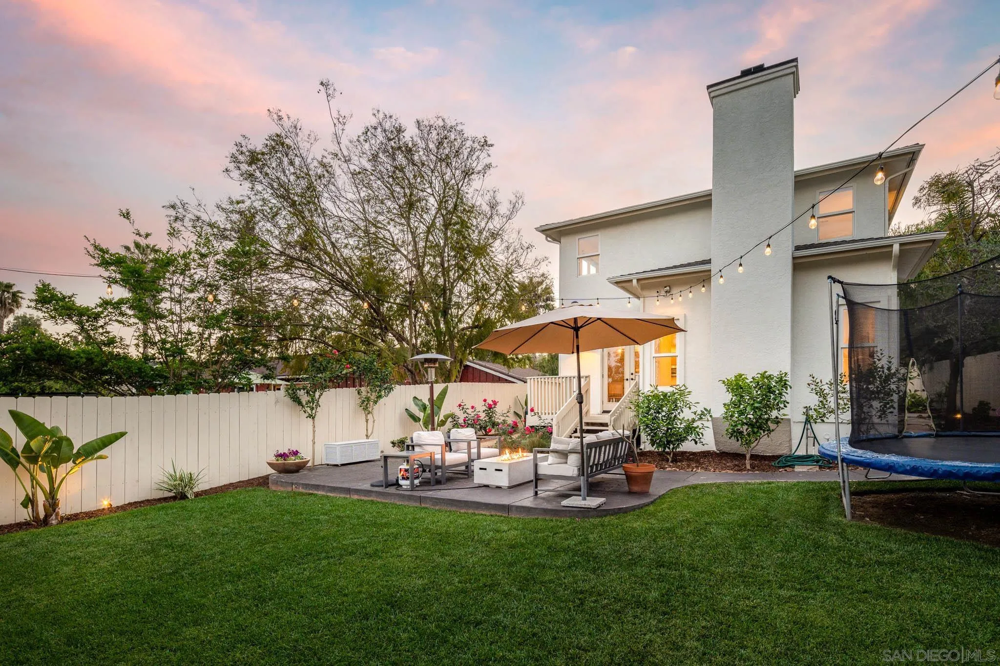 339 Rancho Santa Fe Road Encinitas, CA 92024 - Photo 22 of 36 a view of a patio with couches and a table and chairs under an umbrella