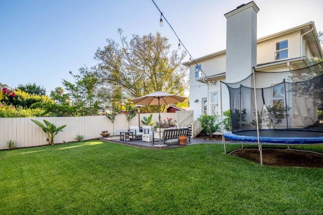 a view of a chair and table under an umbrella