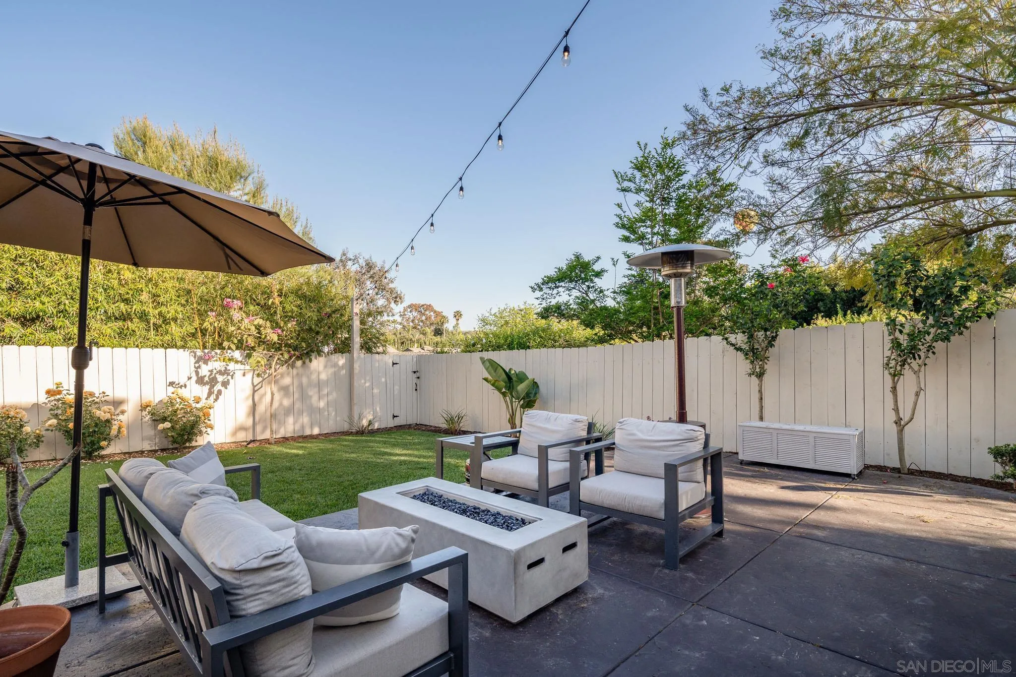 339 Rancho Santa Fe Road Encinitas, CA 92024 - Photo 29 of 36 a view of a patio with couches under an umbrella