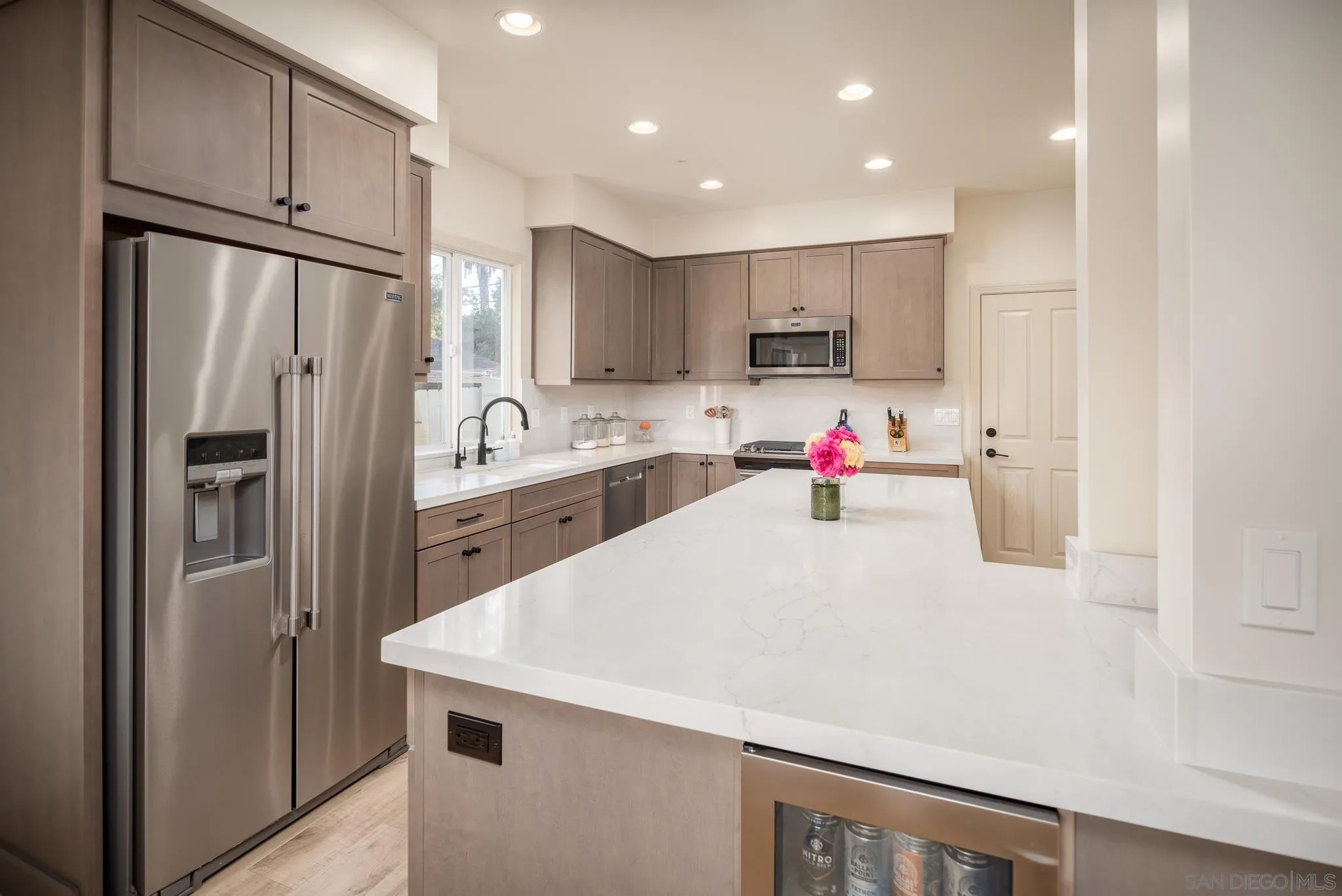 339 Rancho Santa Fe Road Encinitas, CA 92024 - Photo 9 of 36 a kitchen with kitchen island a sink stainless steel appliances and refrigerator
